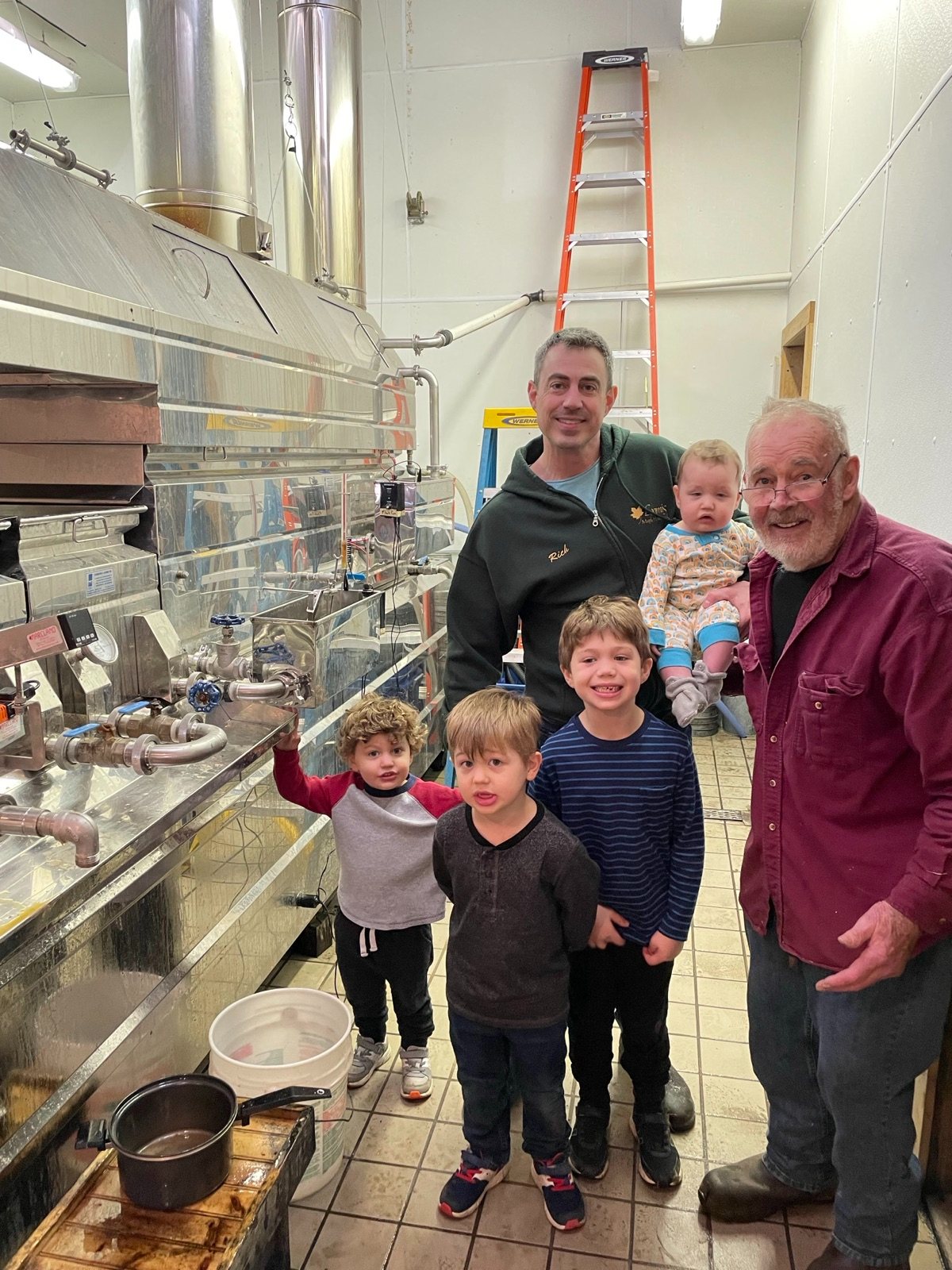 Our family in the sugarhouse by the evaporator